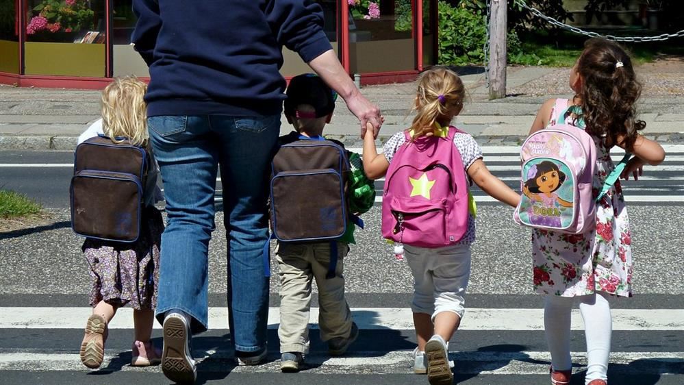 Parent walking child to school Parent walking child to school